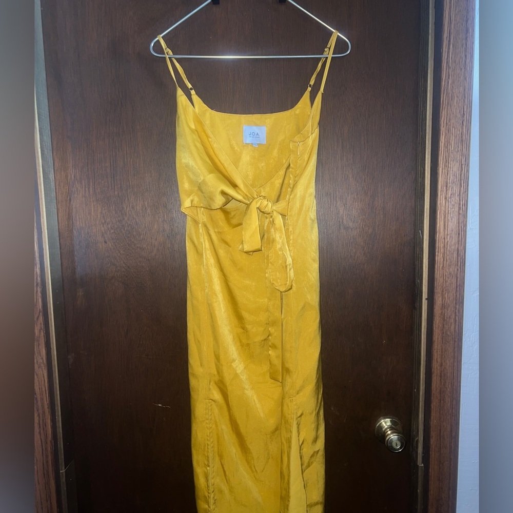 Silky yellow mid length dress and wrap tie on the top.